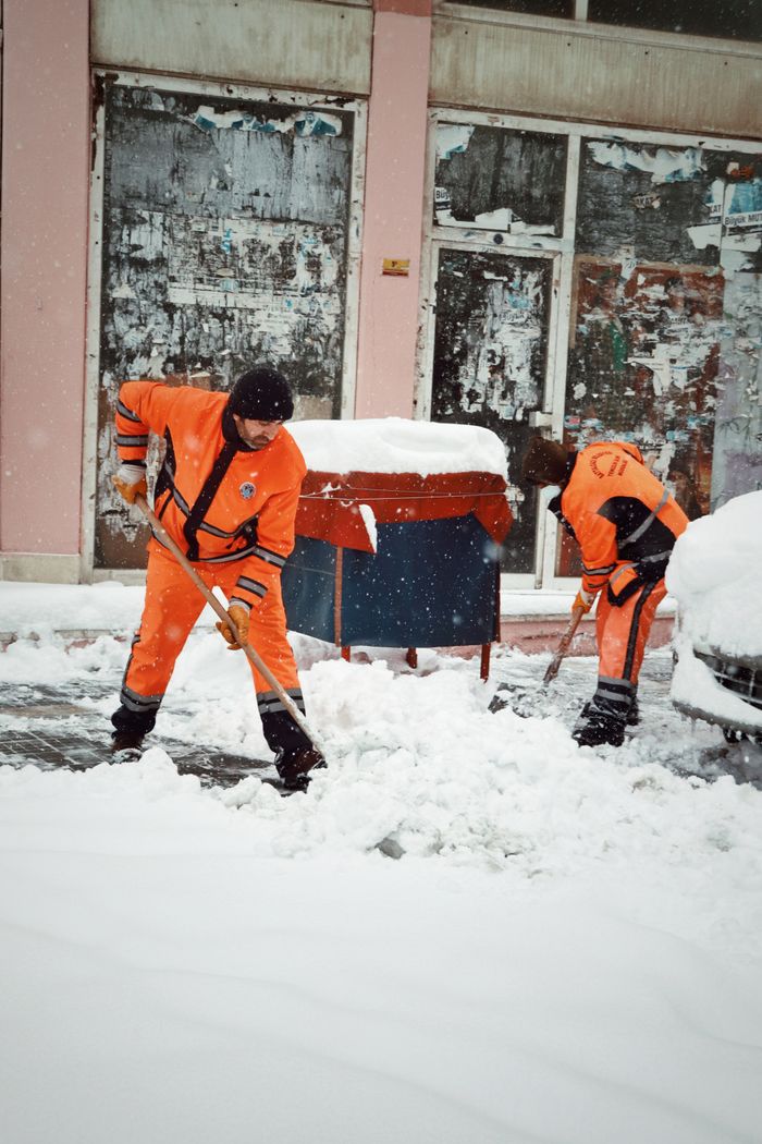 gallery-1 Snow removal workers in bright uniforms clearing streets during a heavy winter snowfall in Malatya, Türkiye.
